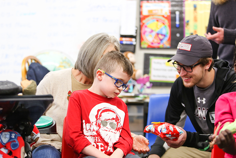 RC student handing gift to elementary student