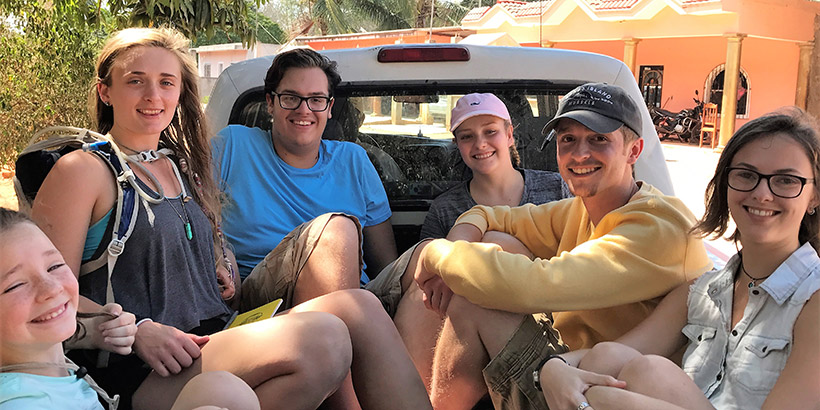 students in the back of a pickup truck