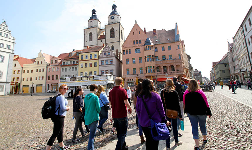 Students walk through the cobblestone streets of a German city