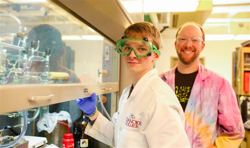 student and professor using lab equipment 