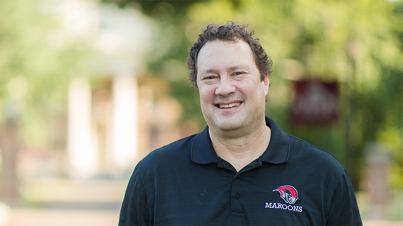 Joe Boucher in a Go Maroons shirt on campus