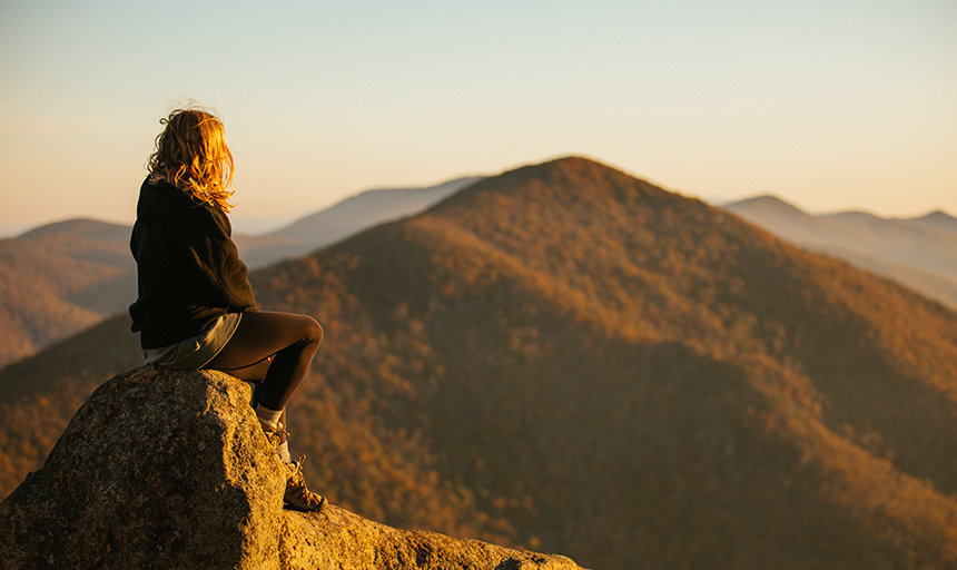 Hiker on top of Mcafee's Knob at dusk