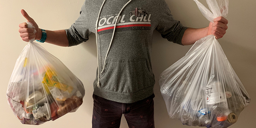 Student holding bags of trash