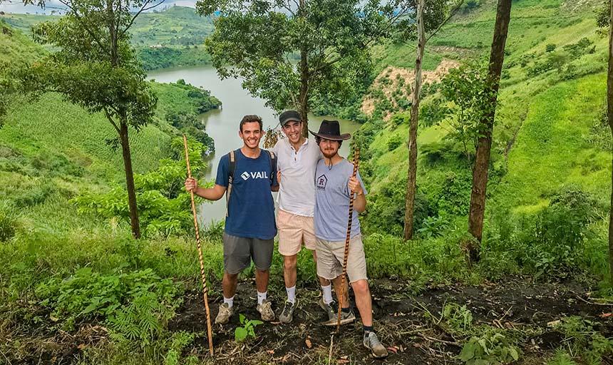 Three students hiking in the mountains of Uganda