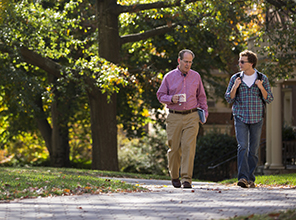 Student and professor walking on campus