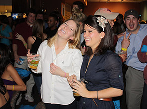 Students smiling and drinking at the 100 Days party