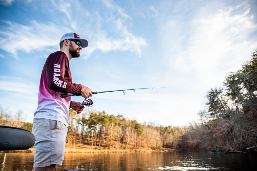 Student at a lake with a fishing rod