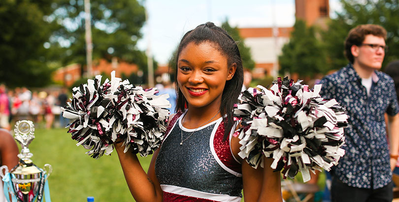 A cheerleader posing at the Activites Fair