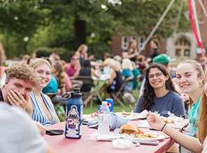 Tables full of students eating at Friday on the Quad