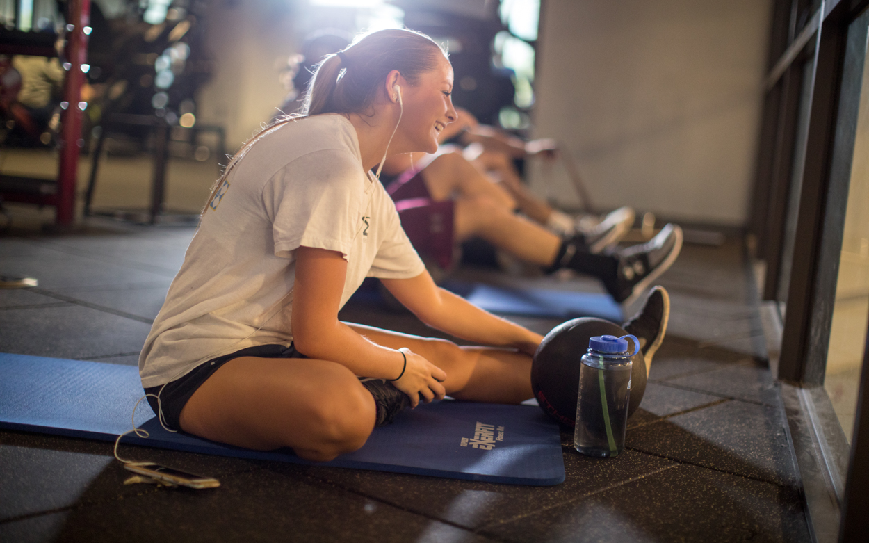 students stretching in the workout center