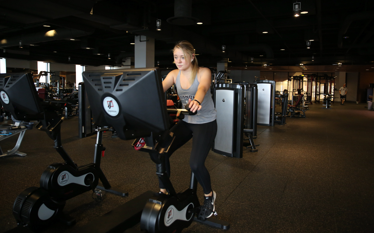 student on bike in belk fitness center