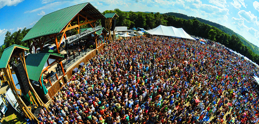 A large crowd congregating at a music festival 