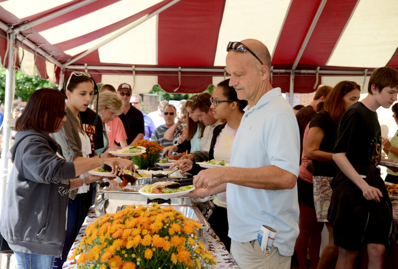 Students getting food from a tent outside