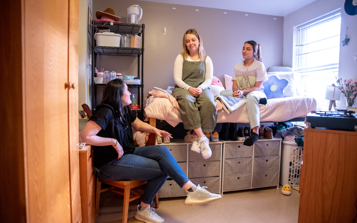 Students relaxing and talking in their dorm