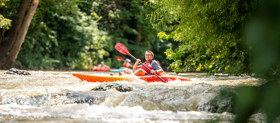 a student in a kayak on the Roanoke River