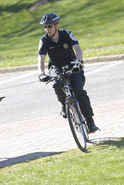 An officer from Campus Safety riding his bike around campus