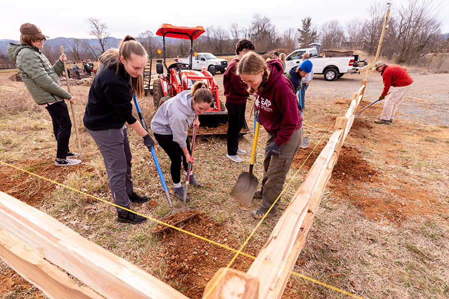 Students digging in a landscaping project