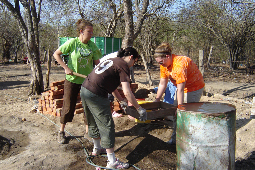 Students working on laying down bricks