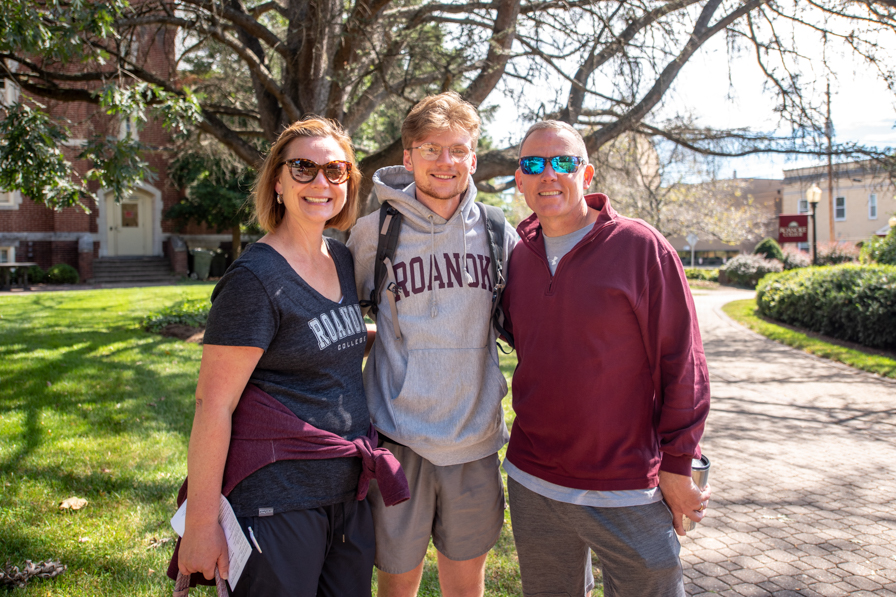 Student and parents stand on the Roanoke campus