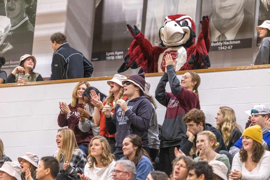 Students and mascot cheer at athletic event