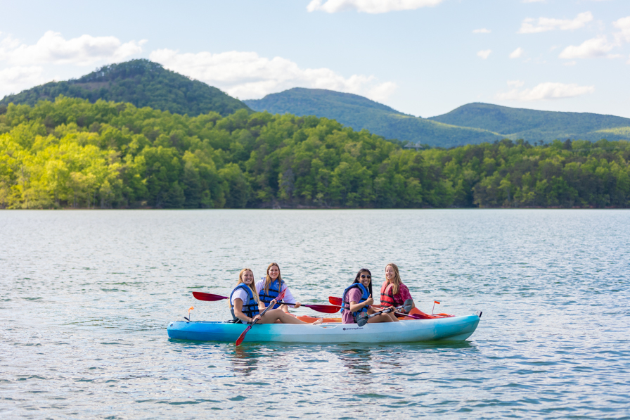 Students paddle on a nearby lake