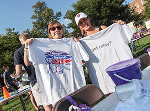 Students holding up Relay For Life t-shirts
