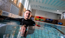 Male student standing in the pool