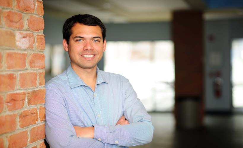 Alumnus, Alex Tuck, posing for a professional head shot.