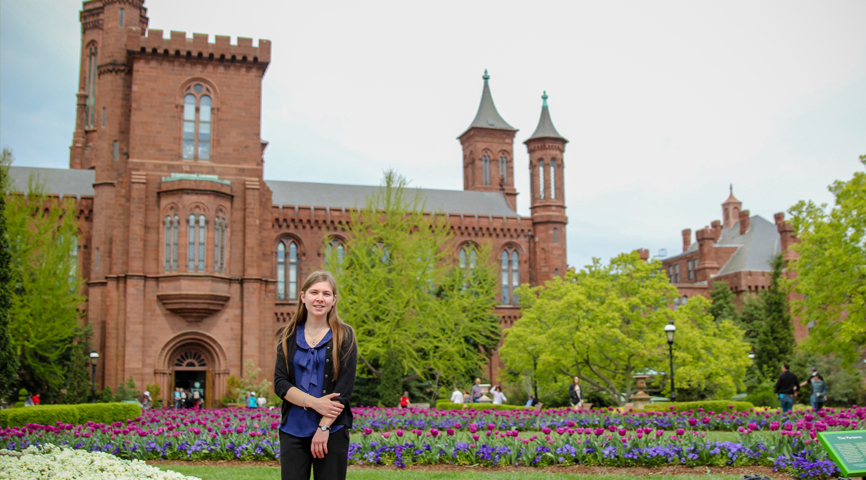 erin keating in front of a building and garden