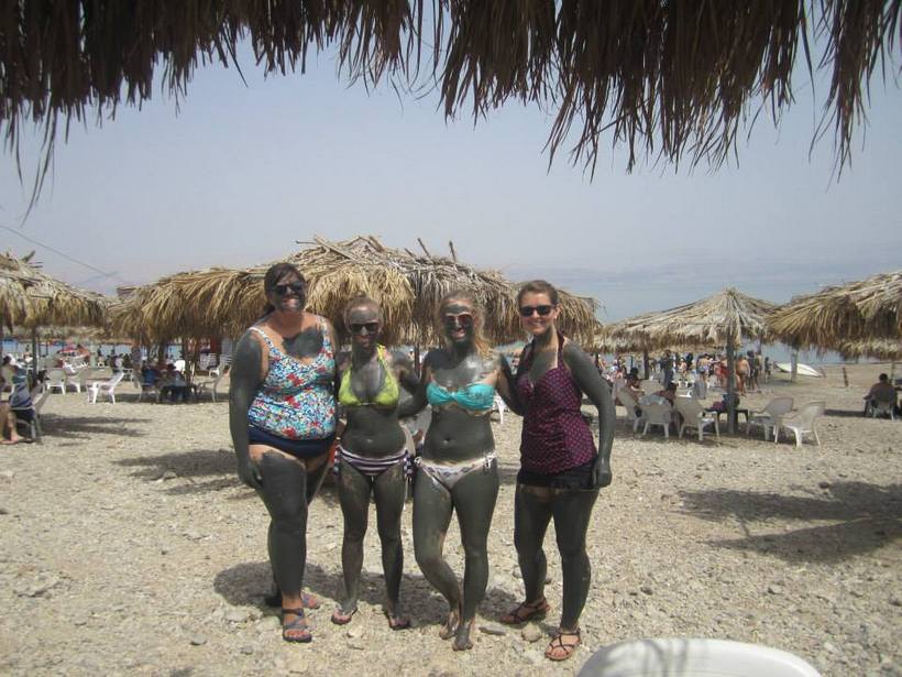 Students covered in mud at the beach
