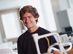 A male student smiling in a lab