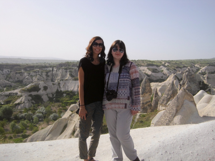 Two girls pose on a hillside