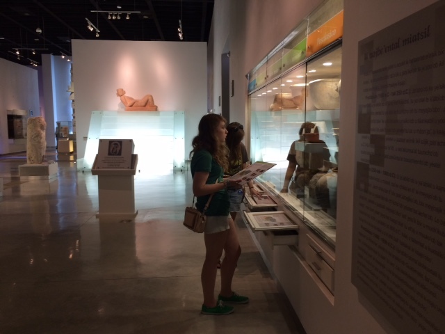 Students looking at artifacts in a museum