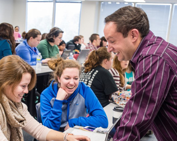 Male professor teaching students in a lecture hall
