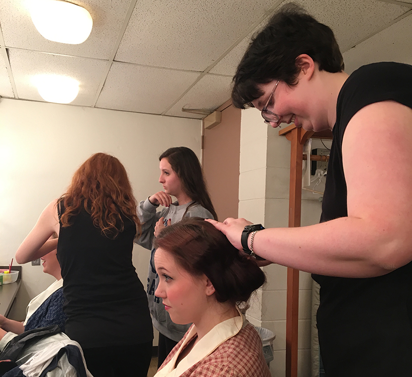 student does a student performer's hair and makeup