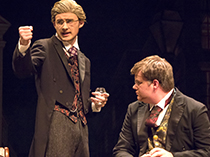 two studente perform in costumes in a production