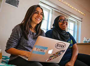 students on their laptops in a dorm room