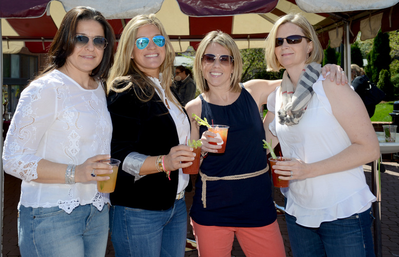 Four alumni pose for a picture.