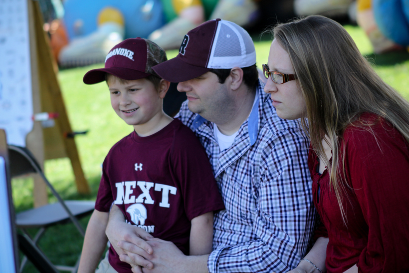 Two alumni with their son