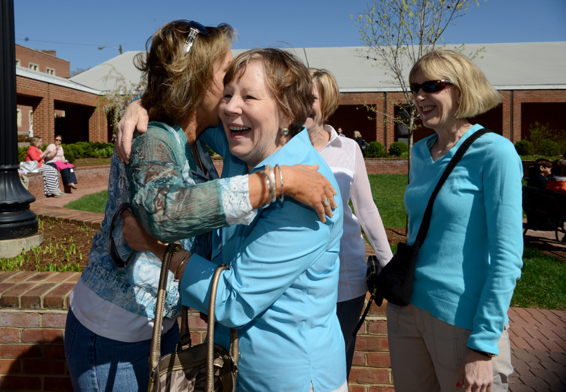 Two alumni hugging on the Olin patio.