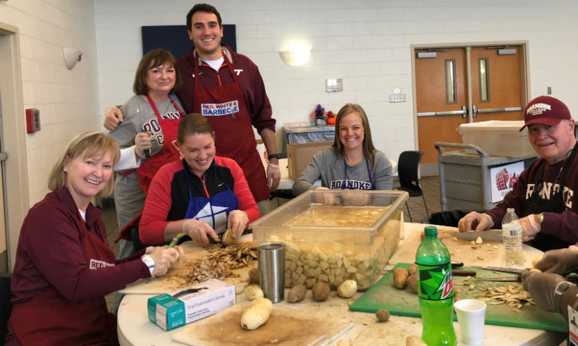 Alumni volunteer (peeling potatoes) at the Rescue Mission
