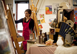 student painting at an easel