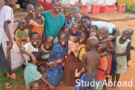 Student with children from a community in a different country