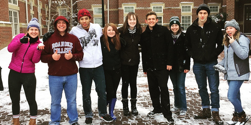 Students standing outside together in the snow
