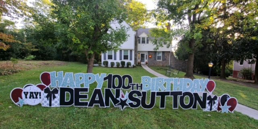 Don Sutton's yard decorated for his birthday with words Happy 100th birthday Dean Sutton
