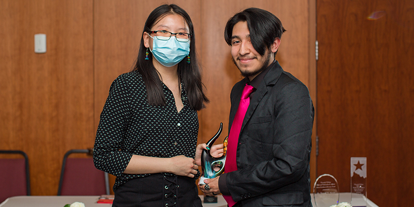 two people holding award