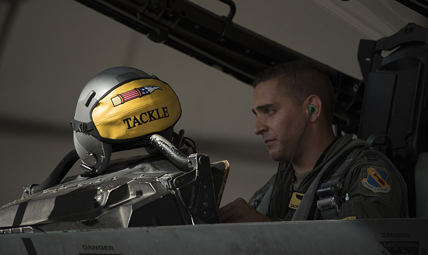 Man in cockpit of fighter jet