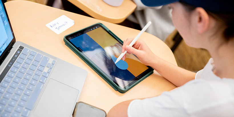 A student creates an illustration of a water drop on a tablet