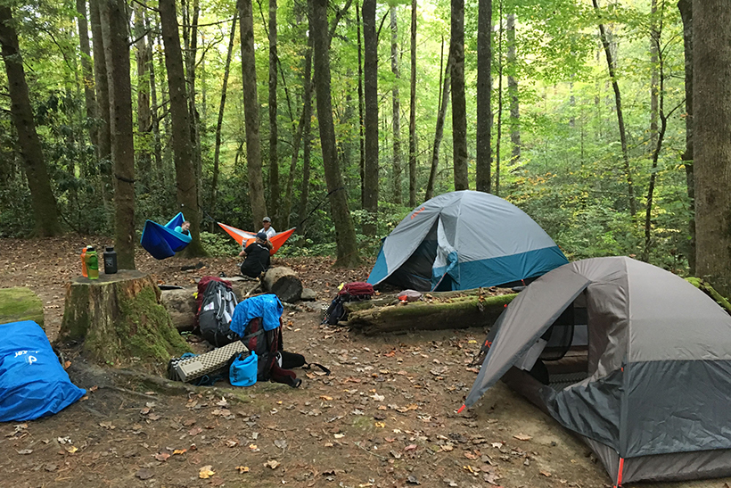 Students at a campsite with tents
