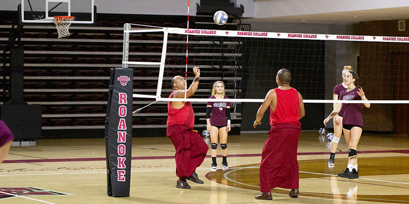 The Tibetan Monks playing volleyball with students